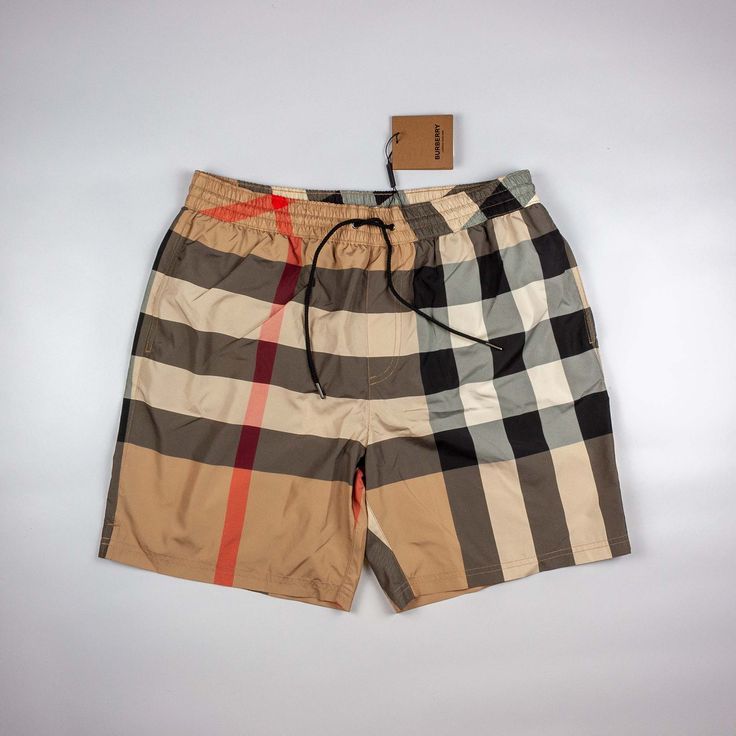 Plaid shorts with a brand tag on a light gray background